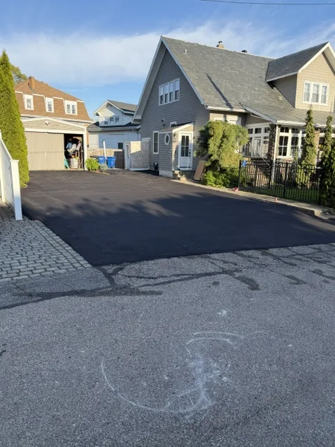New asphalt driveway at a two-family home