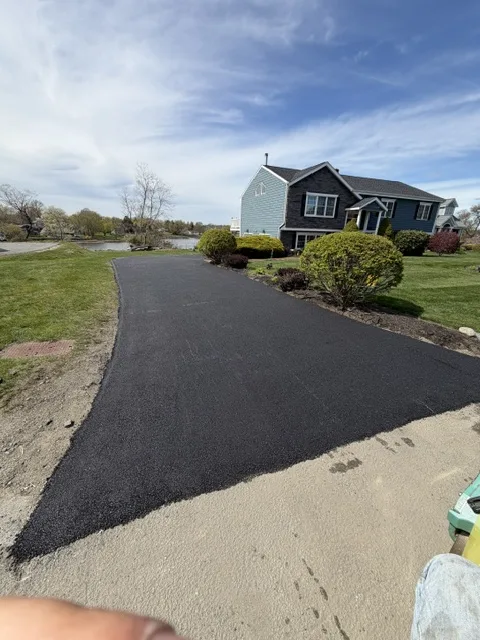 New black asphalt driveway at a waterfront home in Southeastern Massachusetts
